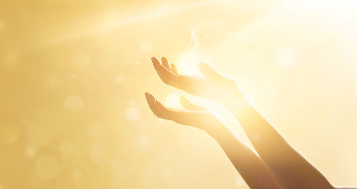 Woman hand praying for blessing from god on sunset background